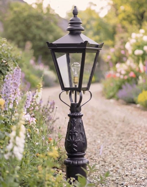 Digital Illustration of the 95cm Harrogate Lantern and Patio Post Positioned on a Flowery Gravel Driveway