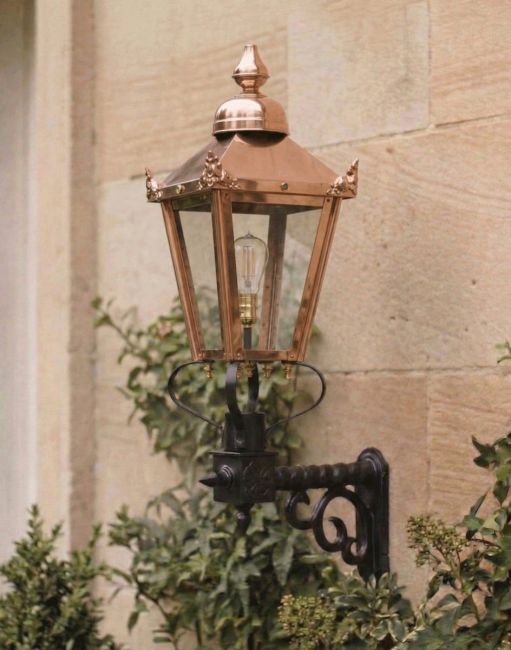 Digital Illustration of the 98 x 46cm Copper Wall Lantern on a Royale Bracket Mounted the Side of a Traditiional Sandstone Brick Building Entrance