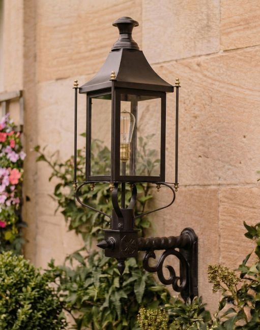 Digital Illustration of the 98 x 66cm Black Victorian Wall Light With Brass Bar Decoration Mounted on the Side of a Sandstone Brick Building