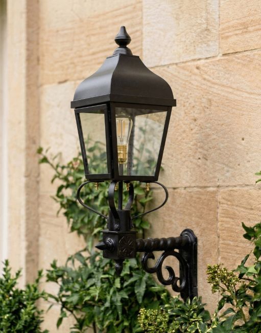 Digital Illustration of the 99 x 51cm "Westwell" Black Simplistic Victorian Wall Light Mounted on a Traditional Sandstone Brick Building wall