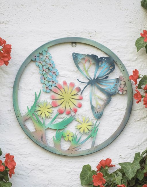 Digital Illustration of the Butterfly and Flowers Silhouette Garden Wall Art Poistioned on a White Garden Wall