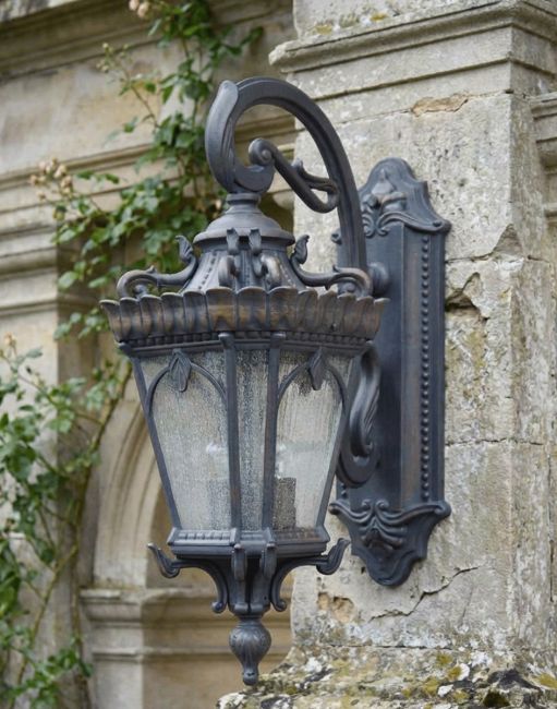 Digital Illustration of the Extra Large Bronze "Cotswold" Ornate Top Fix Wall Lantern Mounted on a Rustic Estate Garden Wall