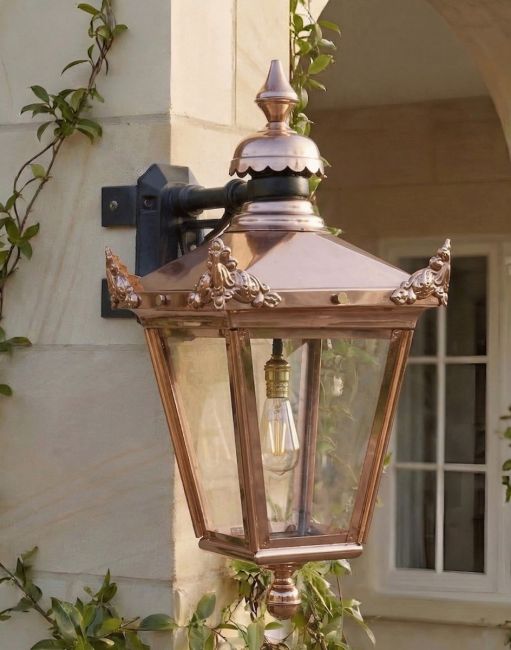 Digital Illustration of the Large 63 x 47.5cm Copper Hanging Corner Wall Lantern Mounted on a Traditional Sandstone Brick Garden Wall