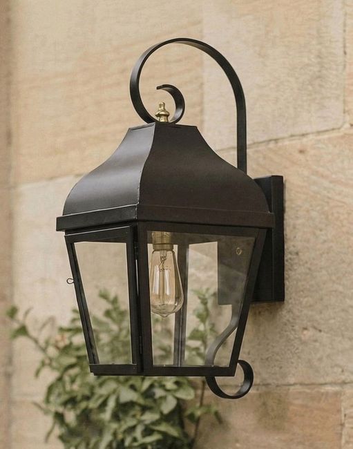 Digital Illustration of the Midnight Black Flush Wall Lantern With Scrolled Bracket Mounted on a Traditional Sandstone Brick Building
