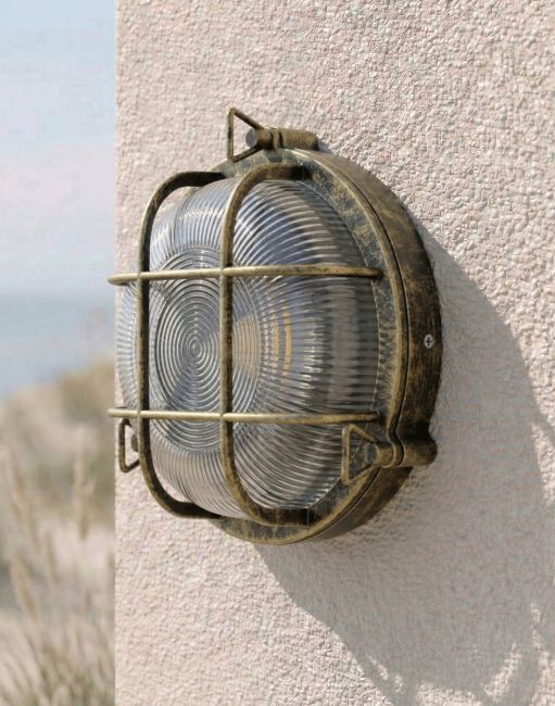 Digital Illustration of the Nautical Round "Cosby" Bulkhead Wall Light in an Antique Brass Finish Mounted on a Cream Coloured Textured Wall