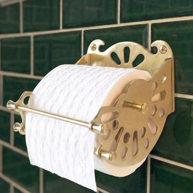 Digital Illustration of the Brass Version of The Victorian ”Mitchell” Toilet Roll Dispenser Holding Toilet Roll on Green Tiles