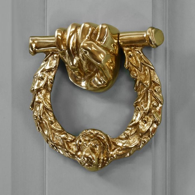Polished Brass Fist & Laurel door knocker on grey door Polished Brass Fist & Laurel door knocker on grey door