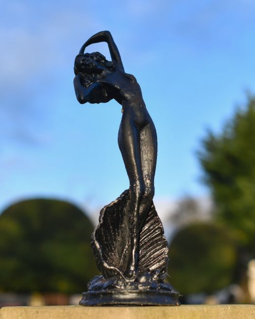 Black Statue Of A Lady In. A Clam In Situ Black Statue Of A Lady In. A Clam In Situ