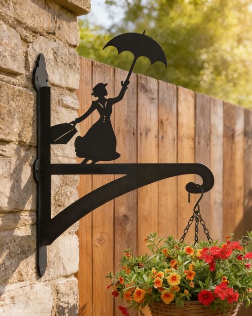 Flying Nanny Iron Hanging Basket Bracket mounted on brick wall with fence in background Flying Nanny Iron Hanging Basket Bracket mounted on brick wall with fence in background