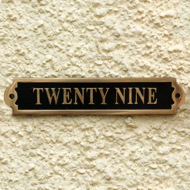 The Number Twenty Nine Displayed on the Black & Brass Gate Number Sign The Number Twenty Nine Displayed on the Black & Brass Gate Number Sign