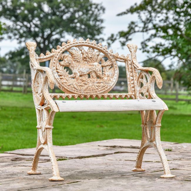 Aged Cream Cast Iron Dog One Seat Park Bench in Use in the Garden Aged Cream Cast Iron Dog One Seat Park Bench in Use in the Garden