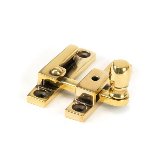 The The Rounded Narrow Quadrant Sash Fastener - Aged Brass on a White Background 