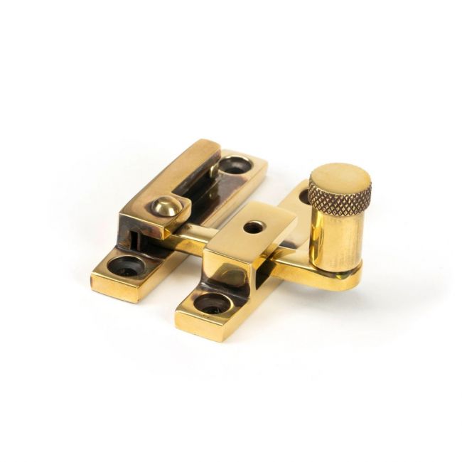 The Knurled Narrow Quadrant Sash Fastener - Aged Brass on a White Background 