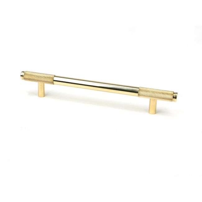 The Medium Half Knurled Cabinet Pull Handle in Polished Brass Shown Upright on a White Background