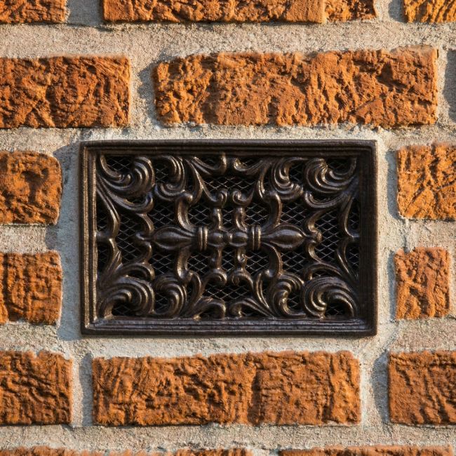 Ornate 9" x 6" Cast Iron Air Brick installed