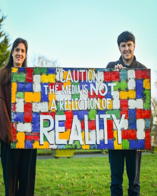 Recycled Oil drum wall art caution the media is not a reflection of reality Smiling