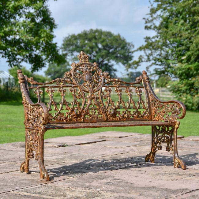 Rustic Cast Iron Gothic Two Seat Bench in Use in the Garden Rustic Cast Iron Gothic Two Seat Bench in Use in the Garden