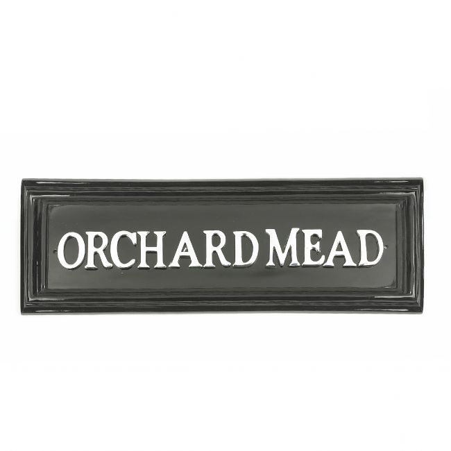 Black rectangular house sign with white letters Black rectangular house sign with white letters