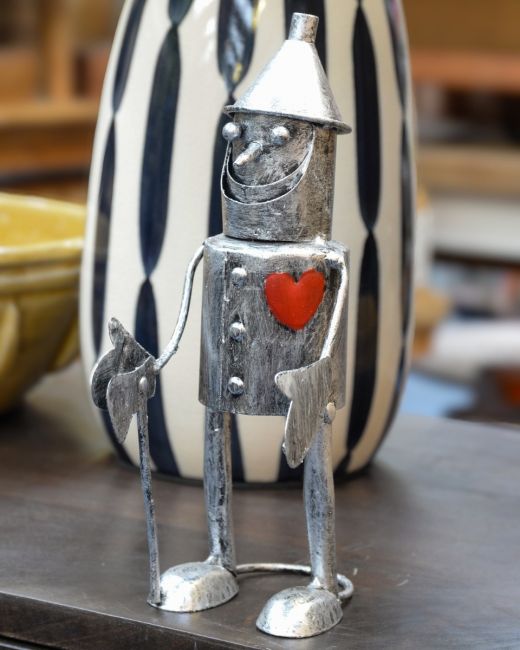 "Rusty" the Tin Man Standing Garden Ornament Stood on a Table next to a Vase