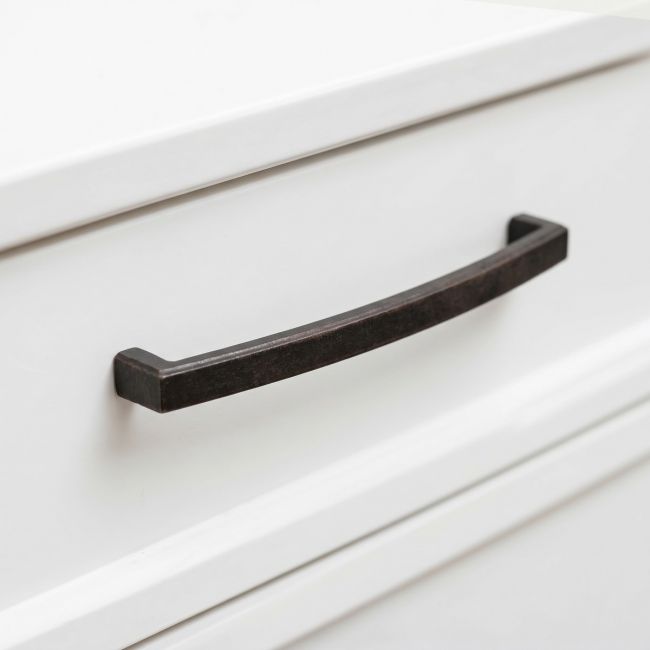 The 8.25" Linear Bridge Pull Handle in Beeswax Stood Upright on a White Background