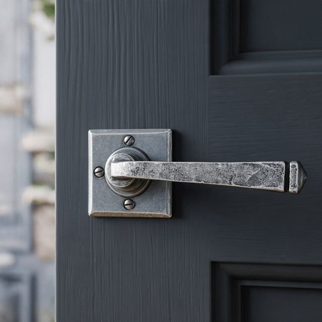 The Arya Unsprung Pewter Iron Door Handle Set On a Grey Door in a Modern Door - Digital Illustration