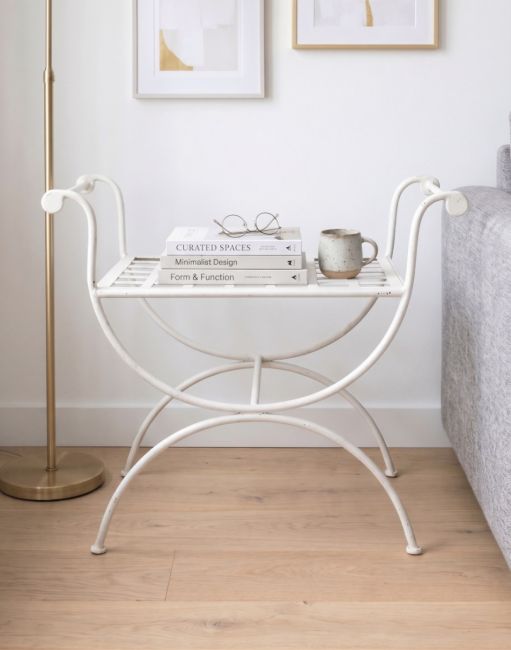 The Athens Single Stool, Or Butler Tray Table in White Shown in a Contemporary Living Room with a Cup and Books on it - Digital Illustration