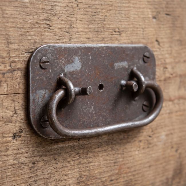The Blacksmith Industrial Chest Drop Handle - 4" Shown on the Side of a Wooden Drawer - Digital Illustration