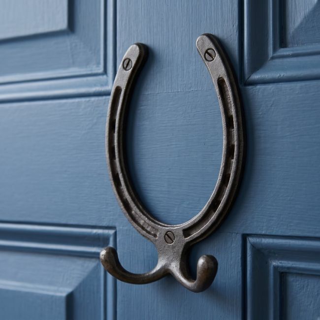 The Blacksmith Vintage Cast Iron Horseshoe Robe Hook Mounted onto a Blue Door - Digital Illustration