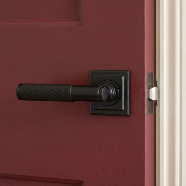 Matte Black Textured Unsprung Lever Door Handle on Square Rose Front