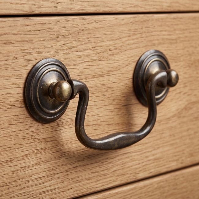 The Georgian Swan Neck Solid Brass Drop Handle - 92mm Shown Close up on a Wooden Drawer - Digital Illustration