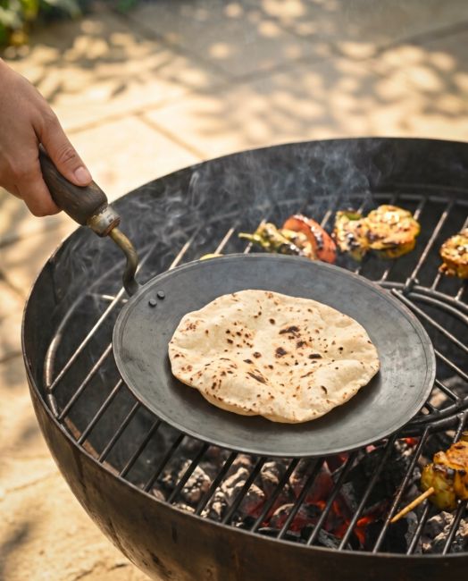 The Kadai Tawa Flat Iron Cooking Pan with Wooden Handle with a Chapati Cooking on the Pan over a Kadai Bowl - Digital Illustration