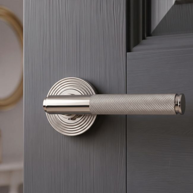 The Knurled Sprung Handle Set on a Beehive Rose in Polished Stainless Steel Shown at an Angle on a White Background