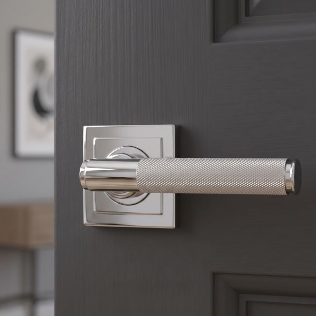 The Knurled Sprung Handle Set on a Square Rose in Polished Stainless Steel Shown at an Angle on a White Background