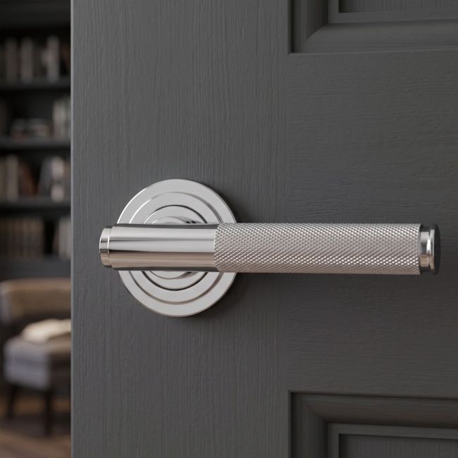 The Knurled Sprung Handle Set on an Art Deco Rose in Polished Stainless Steel Shown at an Angle on a White Background
