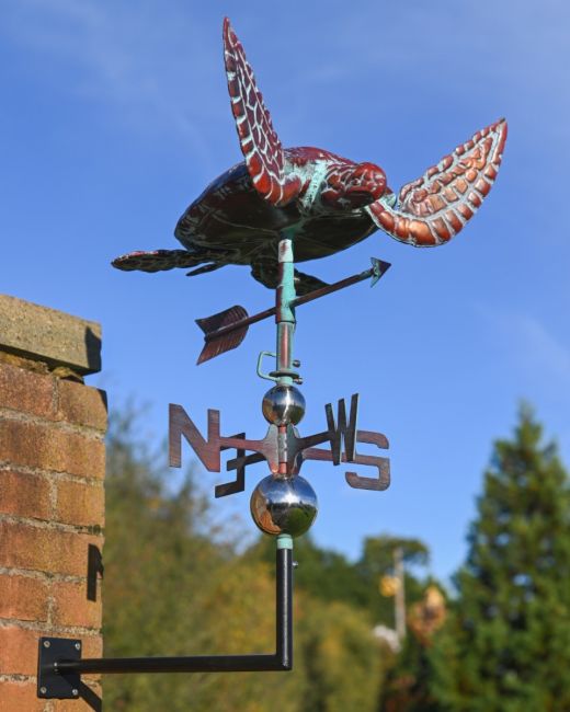 The Mariner’s Reach Sea Turtle Verdigris Copper Weathervane Shown Mounted onto the side of a Building