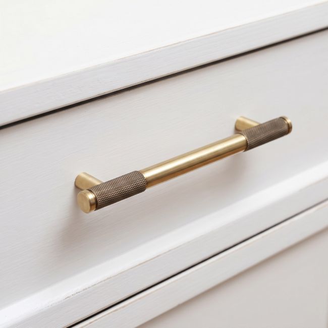 The Medium Half Knurled Cabinet Pull Handle in Aged Brass Shown Upright on a White Background