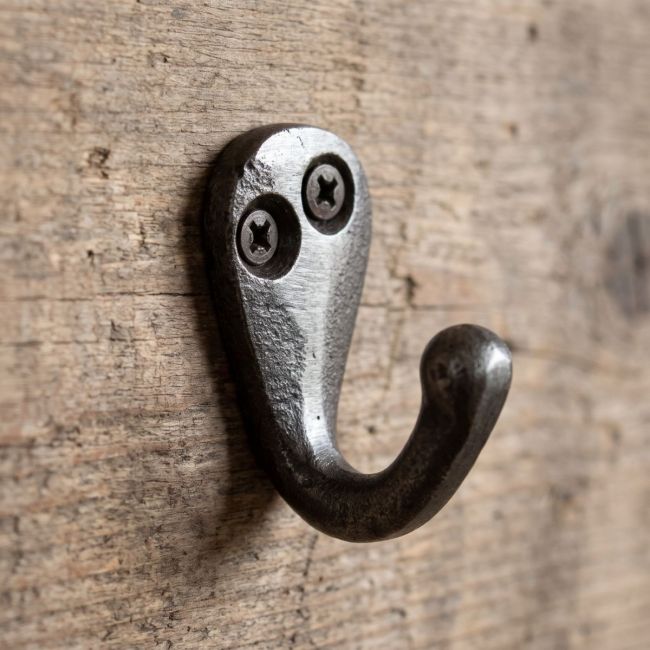 The Mini Single Robe Hook in Cast Antique Iron - 40mm Shown Mounted on a Wooden Board - Digital Illustration