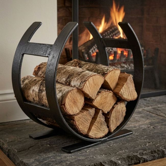 The Small Curved Fireside Log Holder in Matt Black Shown from an Angle on a White Backgroundv