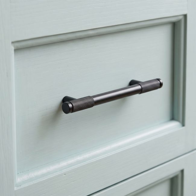 The Small Half Knurled Cabinet Pull Handle in Aged Bronze Shown Upright on a White Background