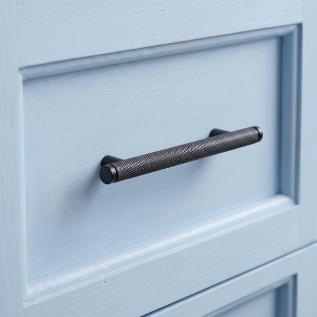 The Small Knurled Cabinet Pull Handle in Aged Bronze Shown Upright on a White Background