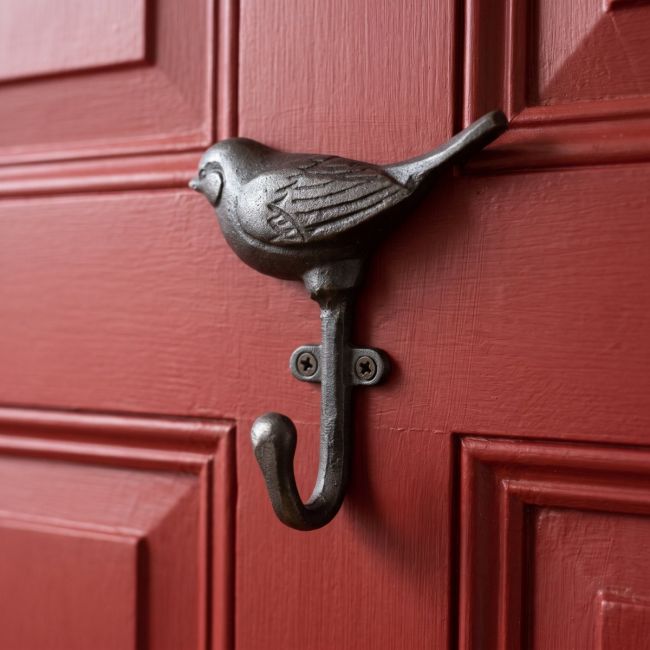 The Songbird Single Cast Iron Coat Hook Shown on a Red Door up Close - Digital Illustration
