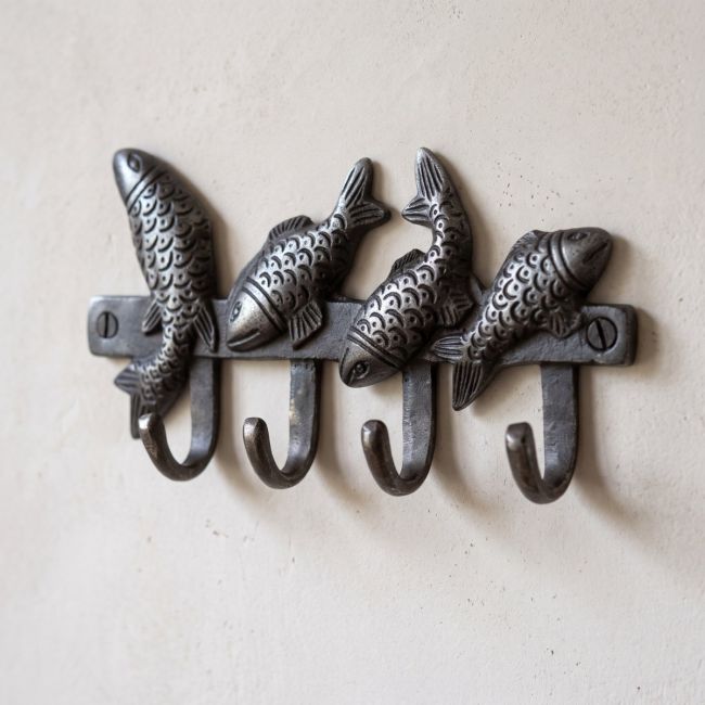 The Swimming Fish 4-Hook Coat Rack in Cast Antique Iron - 170mm on a Cream Coloured Wall - Digital Illustration