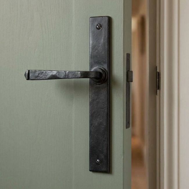 The Tapered Slimline Lever Espagnolette Door Latch in Beeswax on a White Background 
