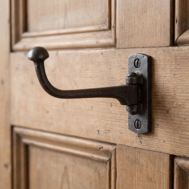 The Victorian Cast Iron Swivel Coat and Wardrobe Hook on the Back of a Timber Door - Digital Illustration