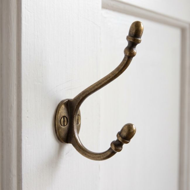 The Victorian Hat and Coat Hook in Antique Copper - 130mm on a White Door in a Period Home - Digital Illustration