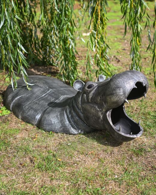 The Zambezi Submerged Hippo Garden Sculpture Shown on a Grassy Lawn in a Sunny Garden
