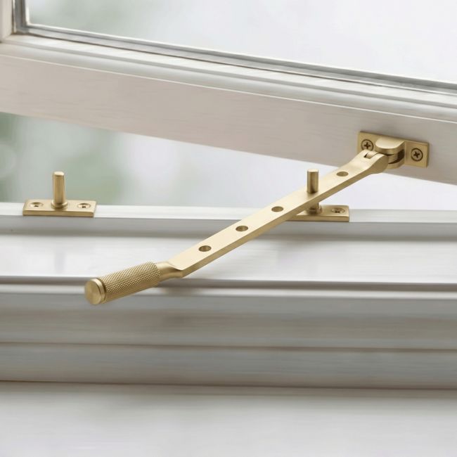 The 12" Satin Brass "Royale" Five Pin Window Stay Fitted on a Classic White Window - Digital Illustration