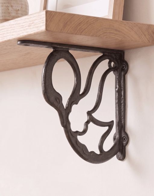 The 17 x 20cm "Coscoroba" Cast Iron Swan Shelf Bracket Mounted on a Cream Coloured Living Room Wall - Digital Illustration 