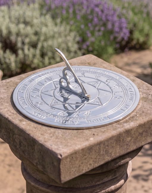The 180mm Bright Chrome Compass Point Sundial Mounted on a Stone plinth in a Sunny Lavendar Garden - Digital Illustration The 180mm Bright Chrome Compass Point Sundial Mounted on a Stone plinth in a Sunny Lavendar Garden - Digital Illustration