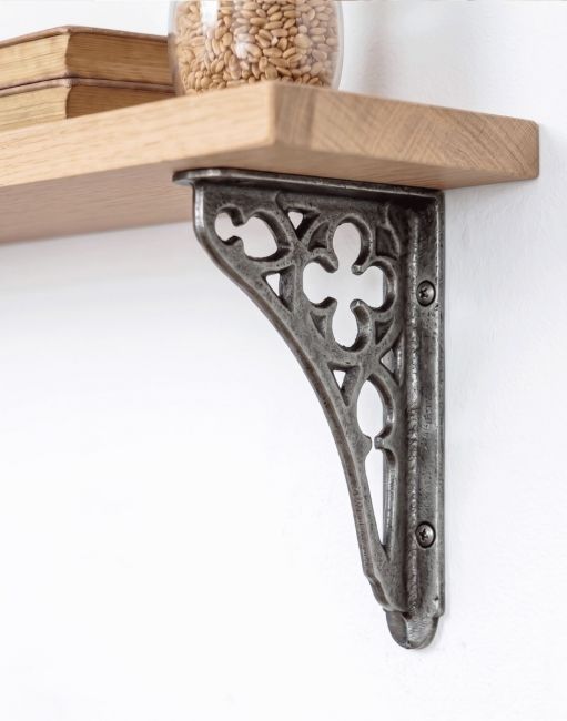 The 18 x 13cm Cast Iron Coalbrookdale Shelf Bracket Mounted on a White Interior Living Room Wall - Digital Illustration 